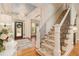 Bright entryway with hardwood floors, elegant staircase, and charming chandelier at 2082 Greenway Mill Ct, Snellville, GA 30078