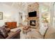 Cozy Gathering room with stone fireplace, built-in shelving, and hardwood floors at 2082 Greenway Mill Ct, Snellville, GA 30078