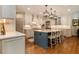 Gourmet kitchen with center island, white cabinetry, and hardwood floors at 2082 Greenway Mill Ct, Snellville, GA 30078