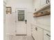 Bright laundry room with custom cabinetry and patterned floor at 2082 Greenway Mill Ct, Snellville, GA 30078