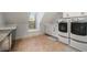 Bright laundry room featuring ample cabinetry and a convenient workspace at 2082 Greenway Mill Ct, Snellville, GA 30078