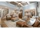 Light-filled living room with hardwood floors, comfortable seating, and a view to kitchen at 2082 Greenway Mill Ct, Snellville, GA 30078