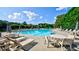 Resort-style community pool with plenty of lounge chairs and umbrellas at 2082 Greenway Mill Ct, Snellville, GA 30078