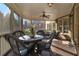 Bright screened porch features wicker furniture, ceiling fan and wood flooring at 2082 Greenway Mill Ct, Snellville, GA 30078