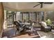 Relaxing screened porch with wicker furniture and wood flooring at 2082 Greenway Mill Ct, Snellville, GA 30078