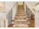 Grand staircase with ornate railing and neutral carpet at 2082 Greenway Mill Ct, Snellville, GA 30078