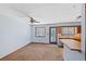 Living room with carpet, ceiling fan and access to kitchen and patio at 285 Independence Dr, Jonesboro, GA 30238