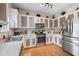 Modern kitchen features stainless steel appliances and ample cabinet space at 311 Tuggle Ct, Woodstock, GA 30188