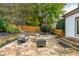 Stone patio with fire pit, seating area, and landscaping at 3214 Burnette Ne Dr, Roswell, GA 30075