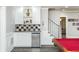 Basement wet bar with white cabinets and a checkerboard backsplash at 3214 Burnette Ne Dr, Roswell, GA 30075