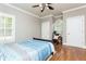 Comfortable bedroom with hardwood floors and a ceiling fan at 3214 Burnette Ne Dr, Roswell, GA 30075