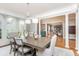 Elegant dining room features a large table, chandelier, and arched windows at 3214 Burnette Ne Dr, Roswell, GA 30075