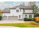 Rear view of a home with three car garage at 3214 Burnette Ne Dr, Roswell, GA 30075