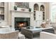 Fireplace with a marble surround and built-in shelving at 3214 Burnette Ne Dr, Roswell, GA 30075