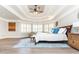 Spacious main bedroom with tray ceiling, large windows, and hardwood floors at 3214 Burnette Ne Dr, Roswell, GA 30075