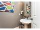 Small powder room with pedestal sink and modern fixtures at 3214 Burnette Ne Dr, Roswell, GA 30075