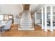 Grand staircase with light-colored carpeting and hardwood floors at 3214 Burnette Ne Dr, Roswell, GA 30075