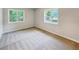 Bright bedroom with neutral carpeting and large windows at 170 Pinehurst Dr, Stockbridge, GA 30281