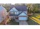 House with fenced backyard, two-car garage, and driveway at 214 Walnut Ridge Rd, Canton, GA 30115