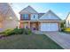 Two-story house with brick and siding, two-car garage and landscaping at 214 Walnut Ridge Rd, Canton, GA 30115