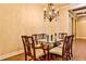 Elegant dining room with chandelier and glass table at 3190 Celebration Blvd, Suwanee, GA 30024