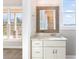 Elegant bathroom with a unique mirror and granite countertop at 607 Walker Ct, Canton, GA 30115