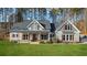 Two-story house with gray siding, brown accents, and a large front porch at 607 Walker Ct, Canton, GA 30115