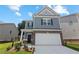 Two-story house with gray siding, white garage door, and landscaped lawn at 730 Brickelberry Court, Marietta, GA 30066