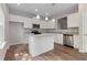 Modern kitchen with white cabinets, granite countertops, and a kitchen island at 730 Brickelberry Court, Marietta, GA 30066