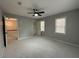 Spacious bedroom with ceiling fan, carpet, and access to hallway at 1028 W Mill Drive Nw, Kennesaw, GA 30152