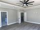 Main bedroom with ceiling fan and ensuite bathroom access at 2902 Centerville Rosebud Rd, Snellville, GA 30039