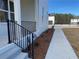 House exterior showcasing a walkway, landscaping, and black metal railing at 2902 Centerville Rosebud Rd, Snellville, GA 30039