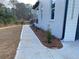 Concrete sidewalk alongside the home with landscaping at 2902 Centerville Rosebud Rd, Snellville, GA 30039