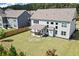 Wide backyard view of a home with a patio, showing its large lawn and surrounding trees at 4259 Hansford Loop, Marietta, GA 30064