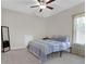 Comfortable bedroom with a ceiling fan, carpet flooring, and natural light from the window at 4259 Hansford Loop, Marietta, GA 30064