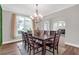 Bright dining room features a chandelier, large window and table for ten at 4259 Hansford Loop, Marietta, GA 30064