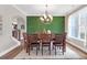 Elegant dining room with modern chandelier, seating for six, and unique moss accent wall at 4259 Hansford Loop, Marietta, GA 30064