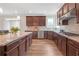 Well-equipped kitchen with stainless steel appliances, dark wood cabinets and granite countertops at 4259 Hansford Loop, Marietta, GA 30064