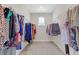 Walk-in closet with carpet floor, a window and hanging racks at 4259 Hansford Loop, Marietta, GA 30064