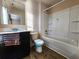 Clean bathroom with tub, toilet and dark vanity at 5150 Amberland Sq, Atlanta, GA 30349