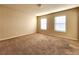 Well-lit bedroom featuring neutral walls and carpet at 5150 Amberland Sq, Atlanta, GA 30349