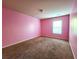 Charming bedroom with pink walls and carpeted floors at 5150 Amberland Sq, Atlanta, GA 30349
