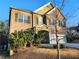 Two-story brick home with a large garage and mature trees at 5150 Amberland Sq, Atlanta, GA 30349