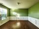 Spacious living room featuring hardwood floors and large windows at 5150 Amberland Sq, Atlanta, GA 30349