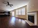 Large living room with hardwood floors and views into kitchen area at 5150 Amberland Sq, Atlanta, GA 30349