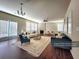 Open living room with hardwood floors, fireplace, and lots of natural light at 5150 Amberland Sq, Atlanta, GA 30349