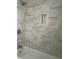 Large tiled shower with built-in niche and modern shower fixtures at 1528 Alder Sw Ln, Atlanta, GA 30311