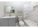 Modern bathroom with gray vanity, marble tile, and a bathtub at 2036 E Camellia Dr, Decatur, GA 30032