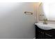 Elegant bathroom with dark vanity, gold fixtures, and a frameless mirror at 2036 E Camellia Dr, Decatur, GA 30032