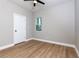 Light-filled bedroom featuring wood-look floors, a ceiling fan, and a window at 2036 E Camellia Dr, Decatur, GA 30032